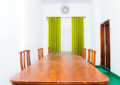 A wooden dining table and chairs at V6 Nest